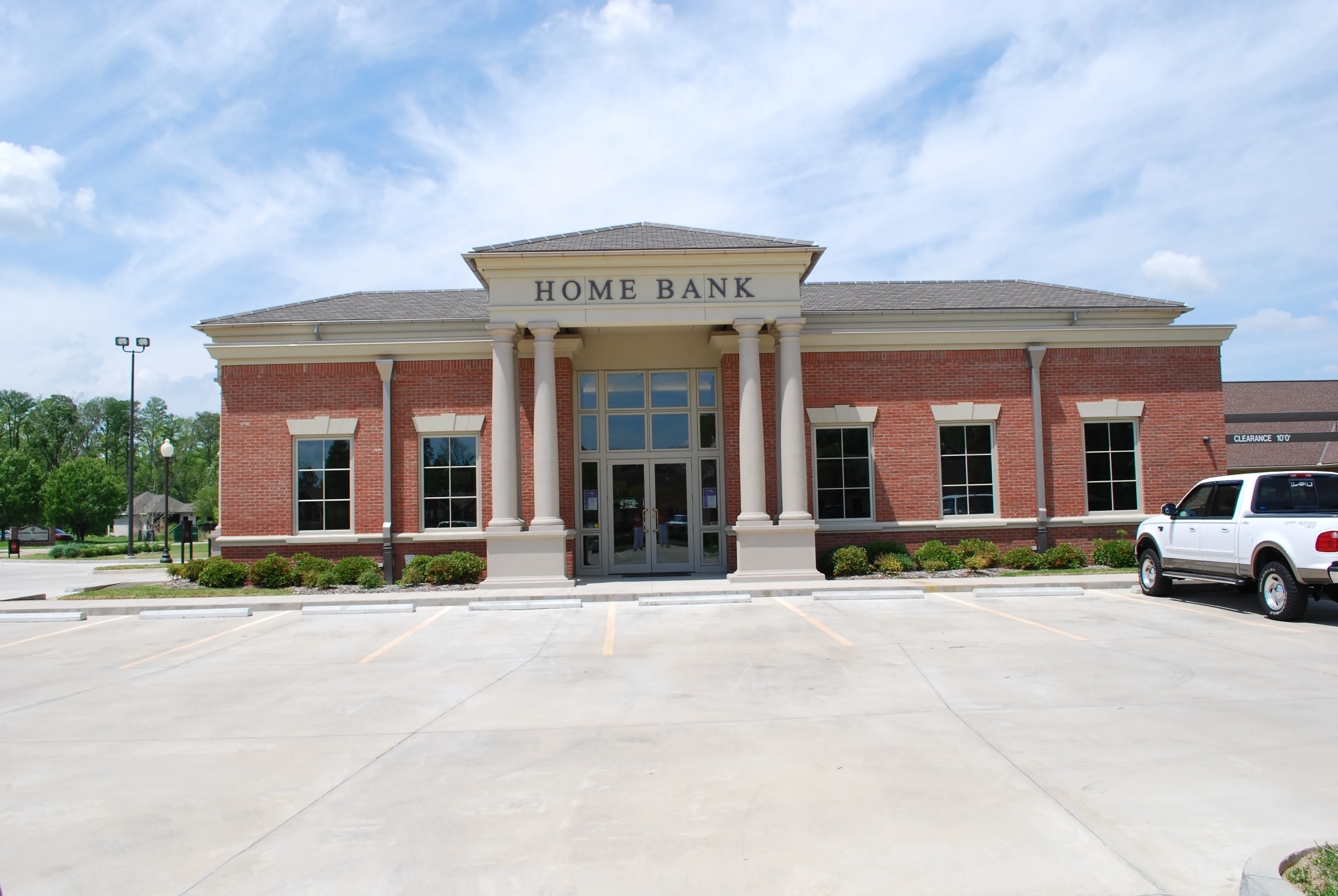 Symmetrical front elevation of the Home Bank branch, with a columned portico and engraved HOME BANK entablature.