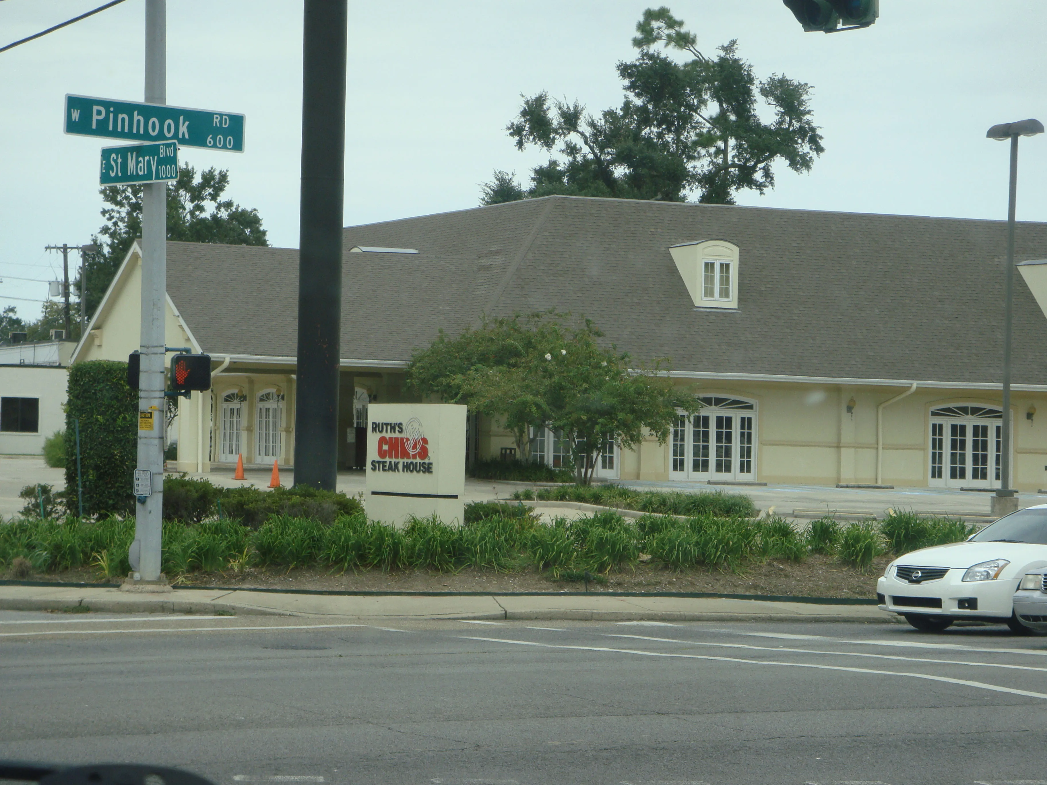 Ruth's Chris Steak House at the Pinhook and St. Mary corner in Lafayette, with its monument sign and hipped-roof building.